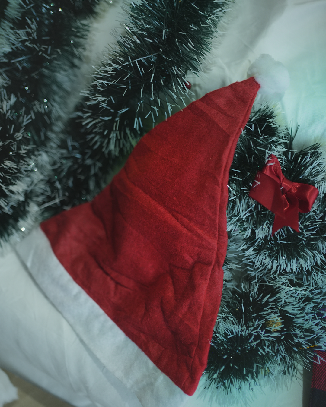 Knitted red Christmas hat with a folded brim and a headband with a star.