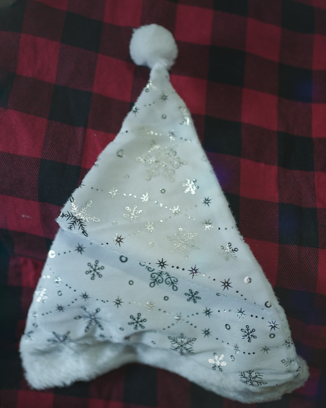 Shop now: Festive white Christmas hat with snowflake design and pom-pom.